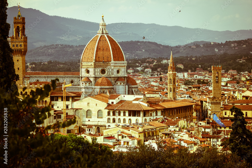 Panoramic view of the city of Florence in the late afternoon with the Florence Cathedral (Cattedrale di Santa Maria del Fiore) in the middle, Tuscany, Italy 