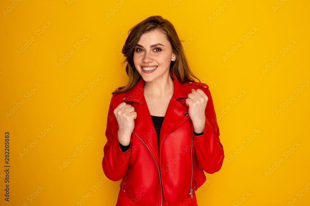 Happy attractive woman celebrating success isolated in a yellow sstudio Happy attractive woman celebrating success isolated in a yellow sstudio