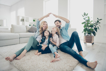 Photo of foster family with two children moving new apartments making arms roof promise protection forever