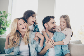 Closeup photo of four family members after adoption spend time rejoicing giggle sit couch living room
