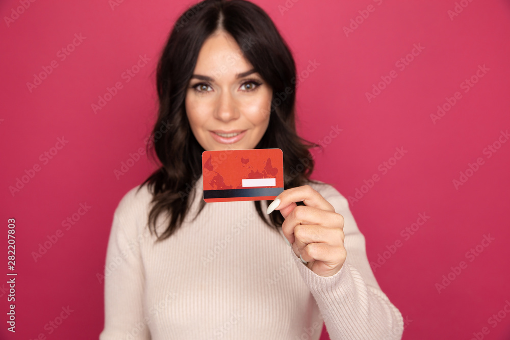 Advertising concept. Lady smiling and showing credit card isolated Advertising concept. Lady smiling and showing credit card isolated