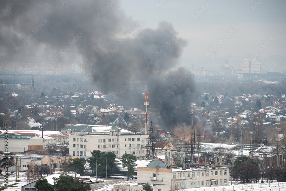 Fire in city on a industrial factory near mobile base station Fire in city on a industrial factory near mobile base station