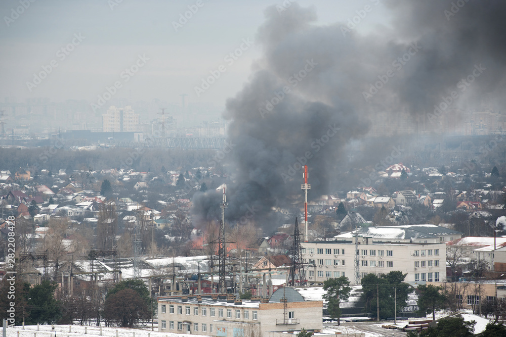 Fire in city on a industrial factory near mobile base station