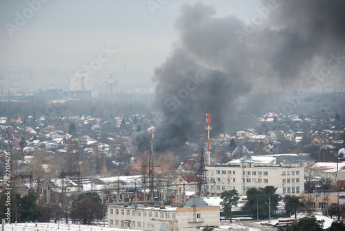 Fire in city on a industrial factory near mobile base station