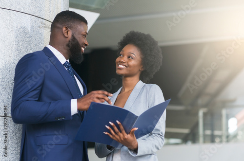 A couple of business partners smiling and making eye contact