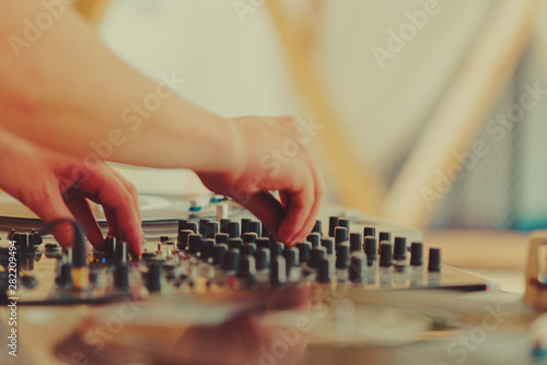 Summer music festival. Dj's sound equipment and people on blurred background.  Shallow depth of field