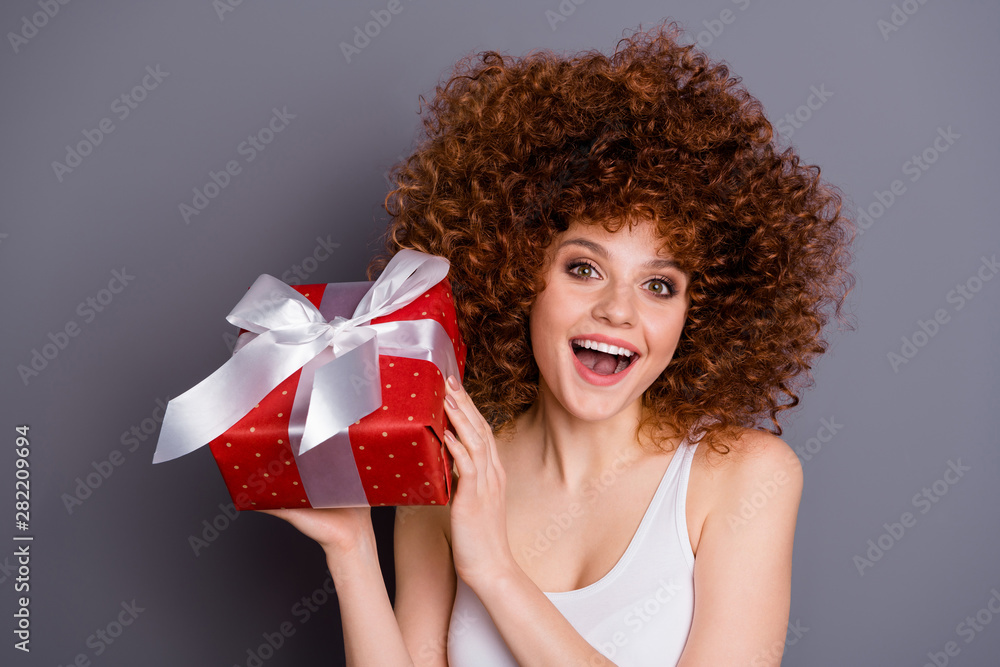 Close up photo of volume hairdo pretty lady big giftbox hands best guest ecstatic wear white tank-top isolated grey background Close up photo of volume hairdo pretty lady big giftbox hands best guest ecstatic wear white tank-top isolated grey background