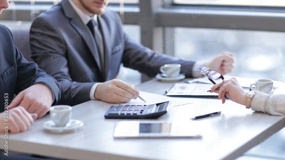 close up.businessman checks the financial data using a calculator close up.businessman checks the financial data using a calculator