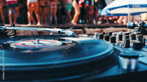 Summer music festival. Dj's sound equipment and people on blurred background.  Shallow depth of field