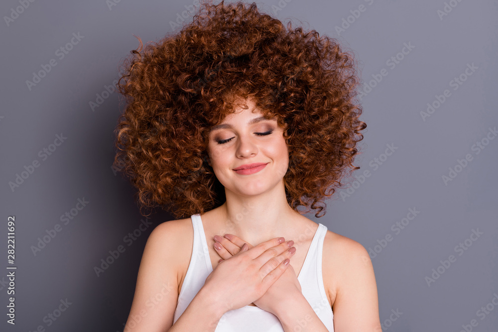 Close up photo of lovely charming youth hands palms touch chest close eyes enjoy isolated over grey background Close up photo of lovely charming youth hands palms touch chest close eyes enjoy isolated over grey background