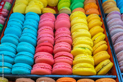 Multicolored French macarons cake in tray for sale at bakery