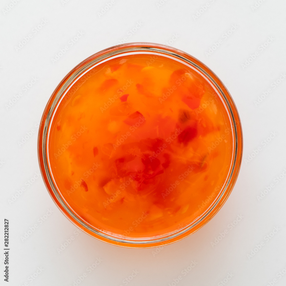 Sweet chilli sauce in a white ceramic bowl isolated on white from above. Sweet chilli sauce in a white ceramic bowl isolated on white from above.