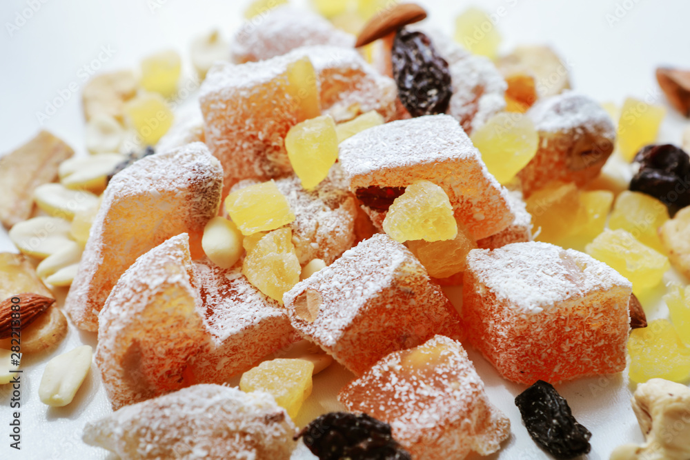 Turkish delight, nuts, dried fruits are mixed on the table Turkish delight, nuts, dried fruits are mixed on the table