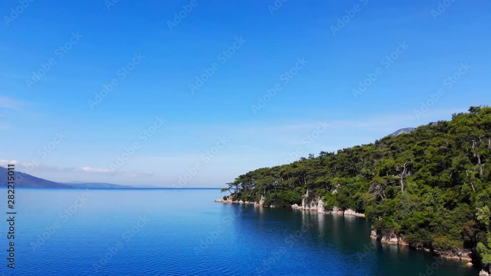 A scenic aerial view of the Aegean Sea and the Gulf of Gokova coastline on a bright summer day. A scenic aerial view of the Aegean Sea and the Gulf of Gokova coastline on a bright summer day.