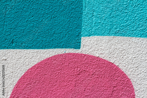 Blue and white painted wall with pink semicircle as background or texture photo