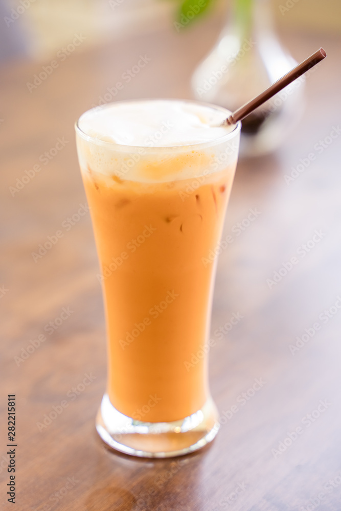 Thai milk tea in the glass with straw Thai milk tea in the glass with straw