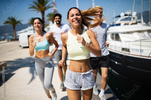 Fototapeta Naklejka Na Ścianę i Meble -  Exercising runners people training outdoors living healthy active lifestyle