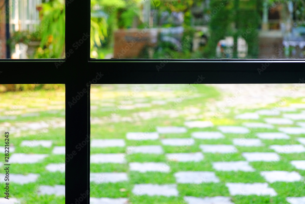 Silhouette of window frame to the green fresh outdoor garden Silhouette of window frame to the green fresh outdoor garden