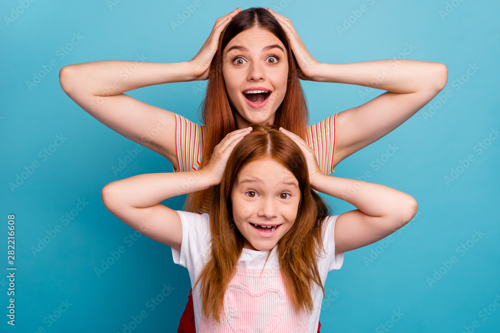 Pretty foxy little lady and her mom listen unexpected great news wear casual clothes isolated blue background