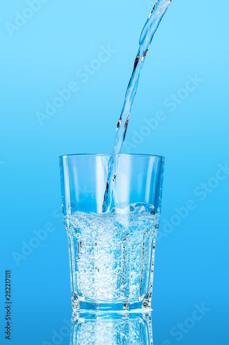 Close up pouring purified fresh drink water from the bottle on table © NewFabrika