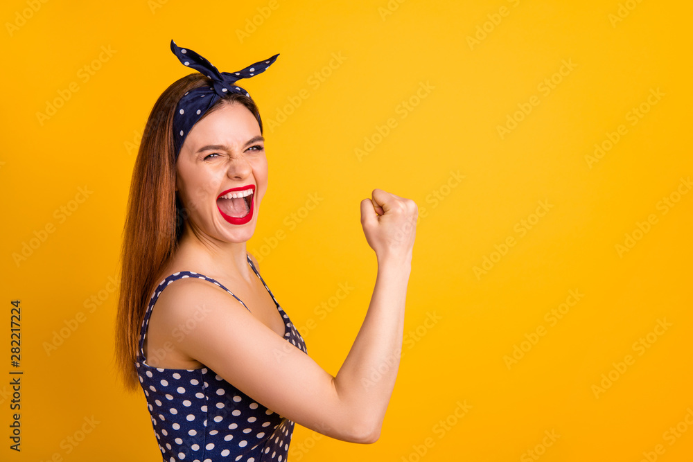Portrait of nice funny lady shout yeah open raise fists isolated over yellow background Portrait of nice funny lady shout yeah open raise fists isolated over yellow background