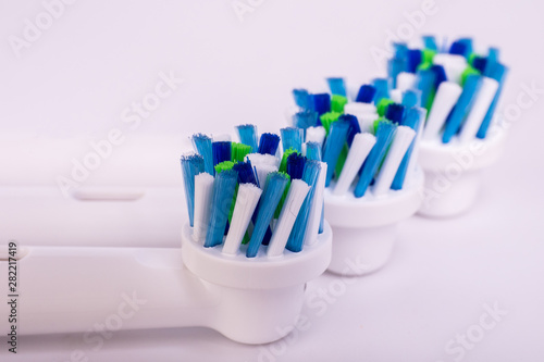Electric toothbrush and dental hygiene accessories on white background.
