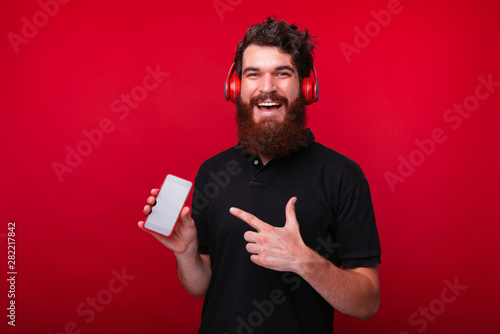 Joyful young bearded man is...