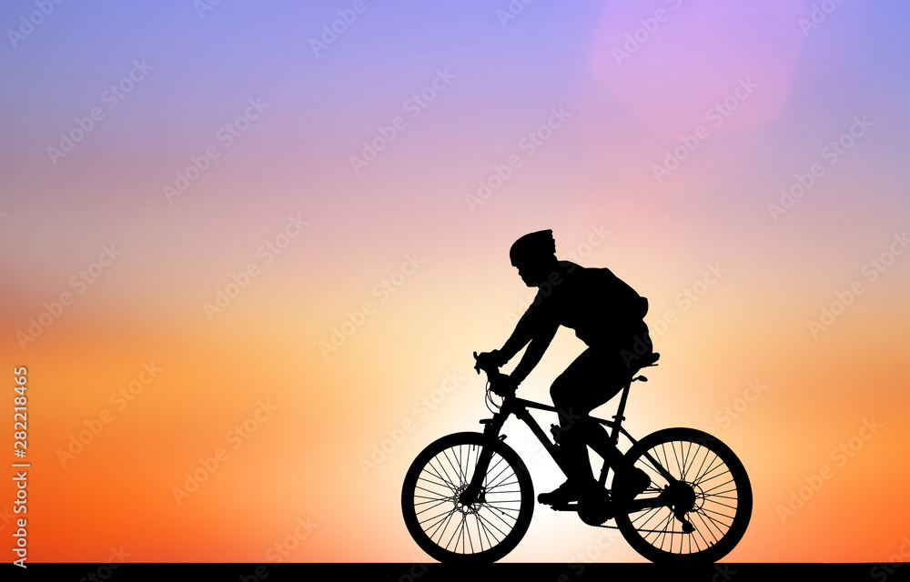 Fototapeta premium Silhouette Cycling on blurry sunrise sky background.