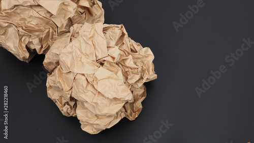 Crumpled brown paper.It is mauled on black background.