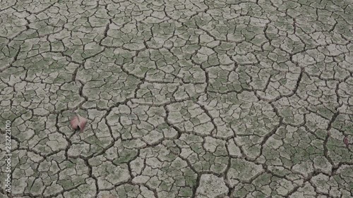 Dry lake bed with natural texture of cracked clay in perspective floor.