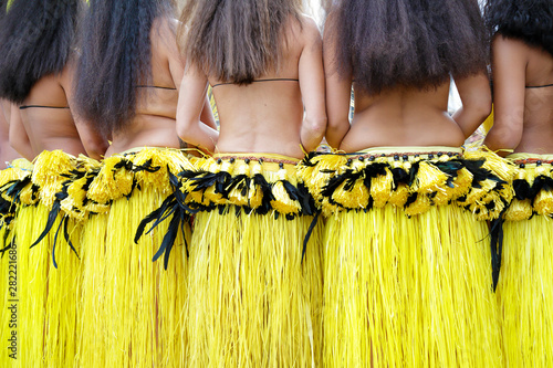 Fotografie Rear view of several dancers wearing the traditional folk costume from Tahiti, F