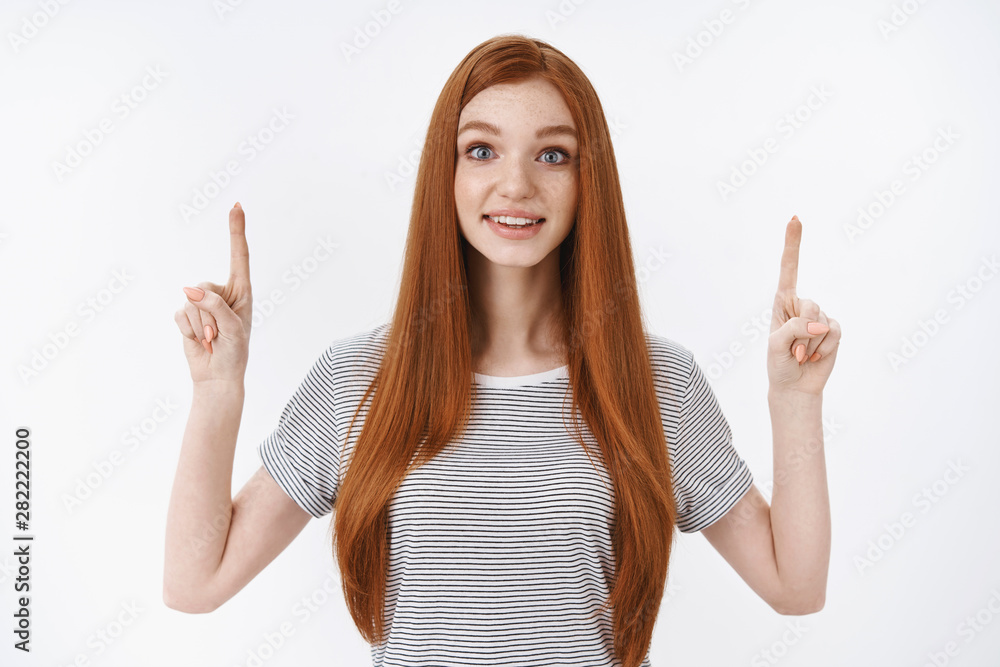 Fascinated impressed redhead good-looking young dreamy girl straight ginger hair widen eyes surprised astonished pointing up look questioned check out awesome product promo intrigued Fascinated impressed redhead good-looking young dreamy girl straight ginger hair widen eyes surprised astonished pointing up look questioned check out awesome product promo intrigued
