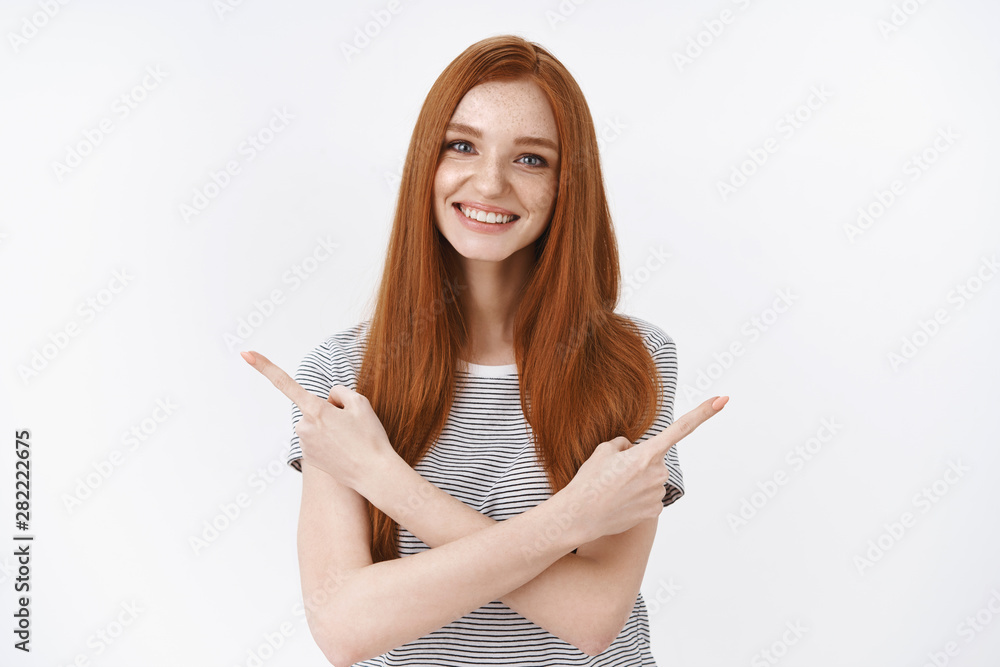 Redhead girl asking you help make choice showing products smiling cute cheerfully pointing sideways crossed hands both sides taking decision, promoting goods standing white background Redhead girl asking you help make choice showing products smiling cute cheerfully pointing sideways crossed hands both sides taking decision, promoting goods standing white background