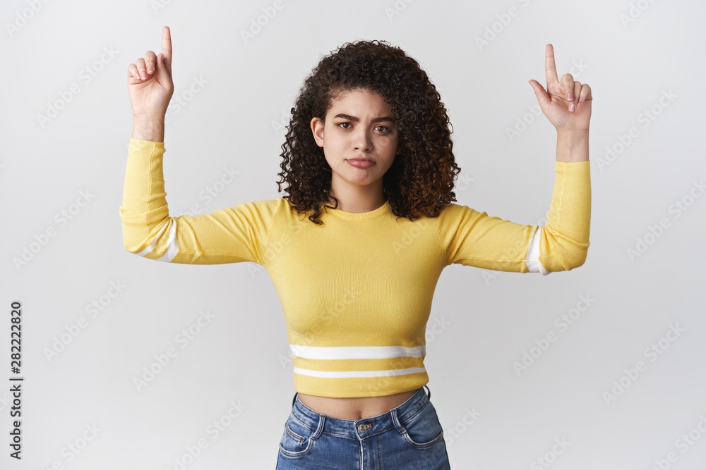 Girl have doubts asking your opinion. Unsure moody upset cute hispanic curly-haired woman pointing up raised hands look hesitant frowning uncertain, perplexed choice, white background Girl have doubts asking your opinion. Unsure moody upset cute hispanic curly-haired woman pointing up raised hands look hesitant frowning uncertain, perplexed choice, white background
