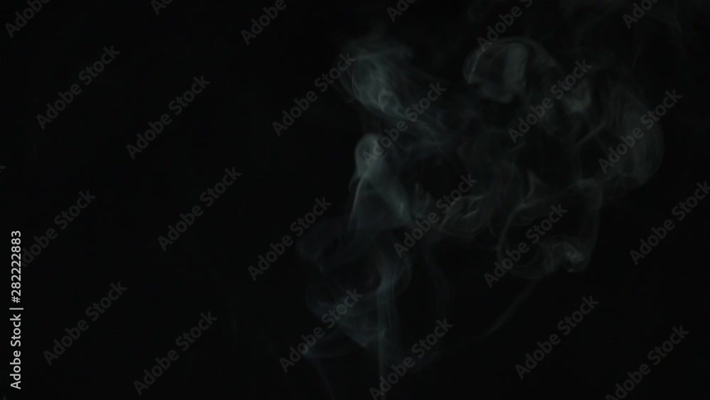 beautiful thick smoke in slow motion, on a black background beautiful thick smoke in slow motion, on a black background