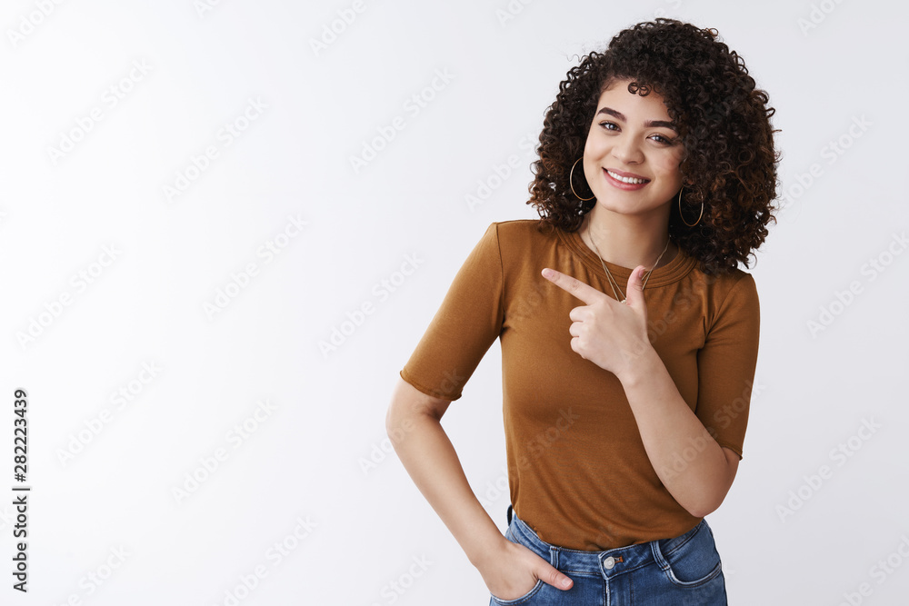 See yourself crazy sale. Cheerful pleasant pretty curly-haired caucasian stylish woman inviting check-out product suggest look left pointing aside index finger grinning delighted, white background See yourself crazy sale. Cheerful pleasant pretty curly-haired caucasian stylish woman inviting check-out product suggest look left pointing aside index finger grinning delighted, white background