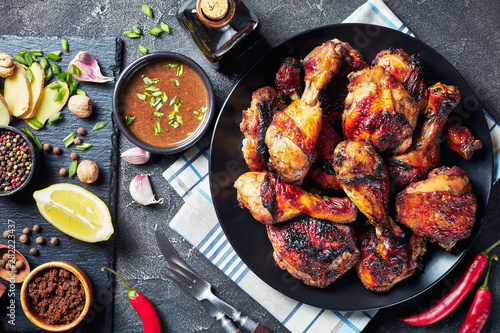 Fototapeta Grilled spicy Jerk Chicken drumsticks and thighs