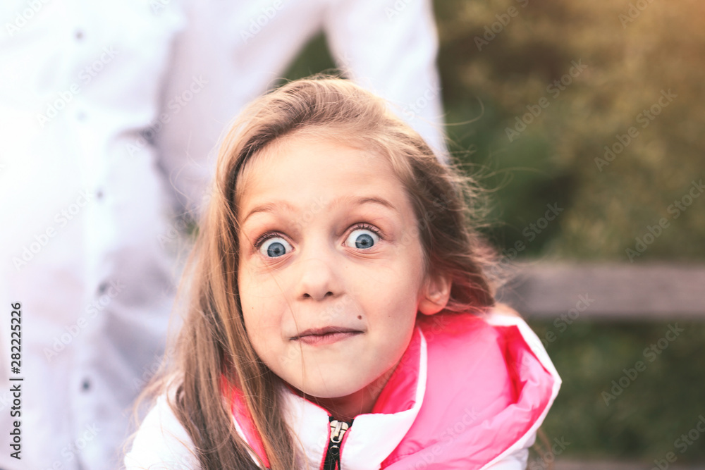 portrait of a surprised little girl on a walk in the Park on a S portrait of a surprised little girl on a walk in the Park on a S