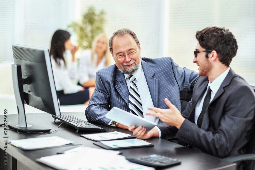 two businessmen discuss the company's financial plan two businessmen discuss the company's financial plan