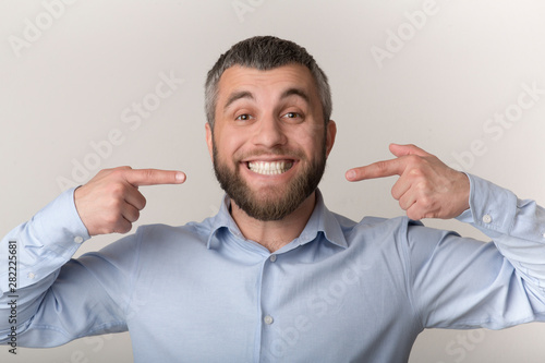 Fotografie Caucasian man smiling and showing perfect teeth