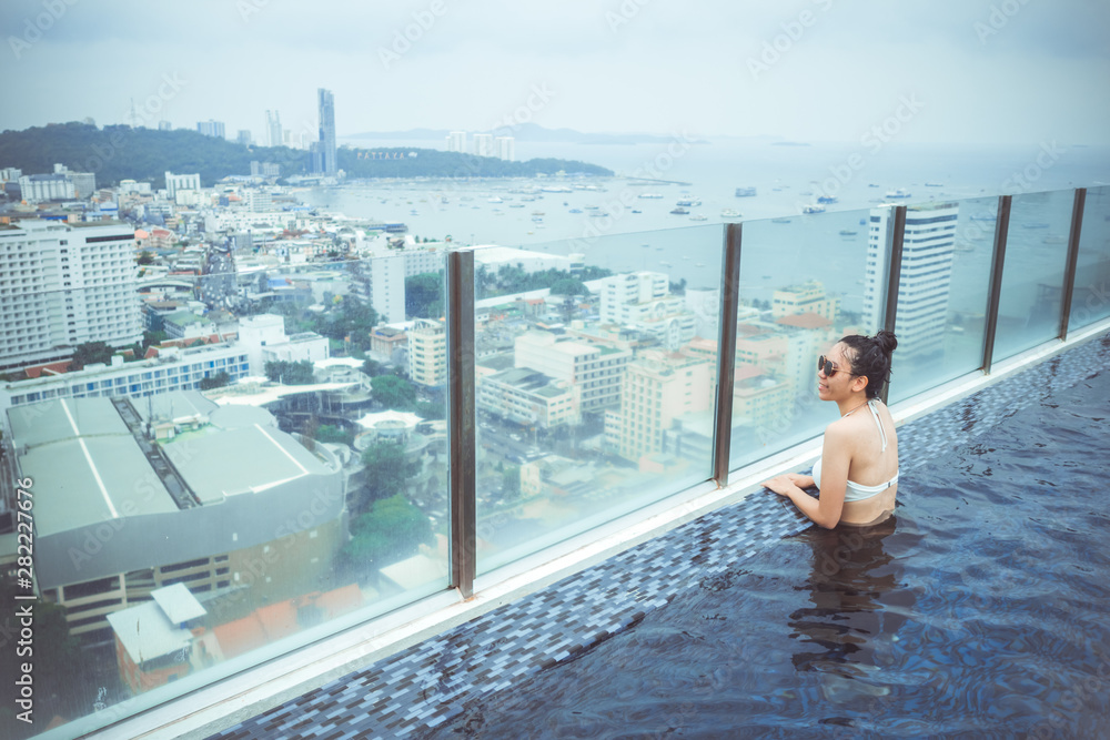 Swimming pool on roof top with beautiful city view, seascape city view, Pattaya, Thailand