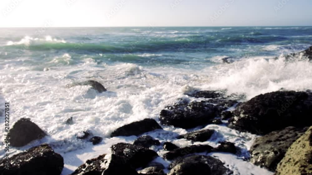 Slow motion video of ocean waves crushing rocky coast. Awesome power of waves breaking over dangerous rocks Slow motion video of ocean waves crushing rocky coast. Awesome power of waves breaking over dangerous rocks