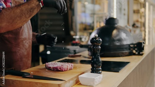 Wallpaper Mural Chef salts steak before grilling in a restaurant Torontodigital.ca