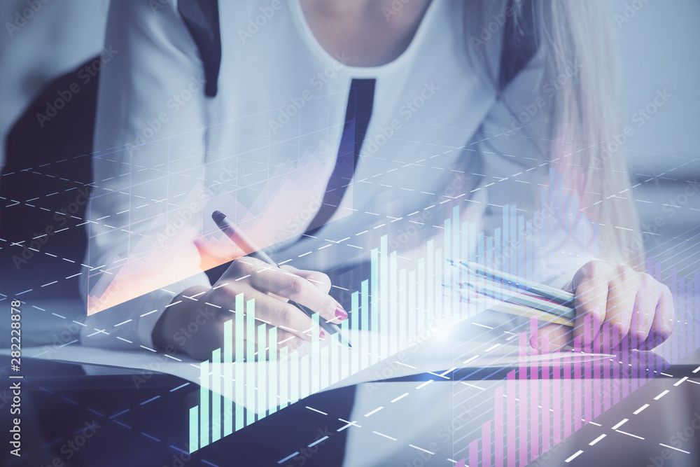 Double exposure of hands making notes with forex chart huds. Stock market concept. Double exposure of hands making notes with forex chart huds. Stock market concept.