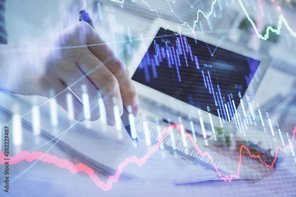 Financial forex graph drawn over hands taking notes background. Concept of research. Multi exposure Financial forex graph drawn over hands taking notes background. Concept of research. Multi exposure
