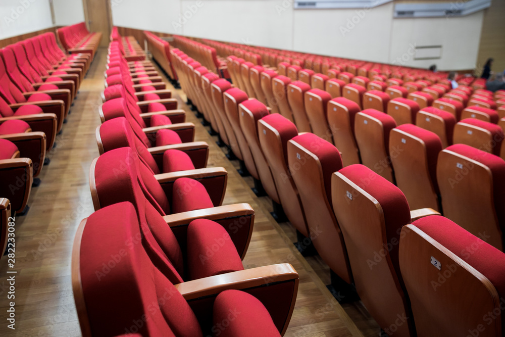 Fototapeta premium Close-up shot of red chair seats in empty conference room
