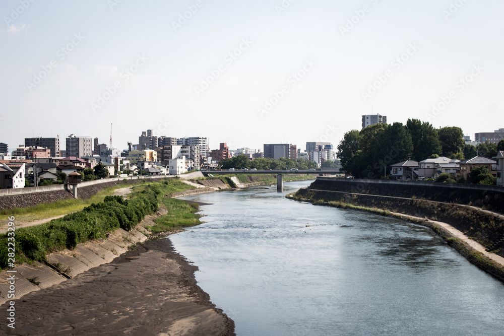 Cityscape of Kokai and Shirakawa river from Kokai bridge, Kumamoto, Japan. Kokai area is located in the heart of Kumamoto city.