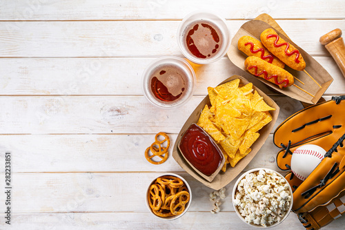 Photography Selection of stadium game foods - nachos, pop corn, pretzels, corn dogs, rustic