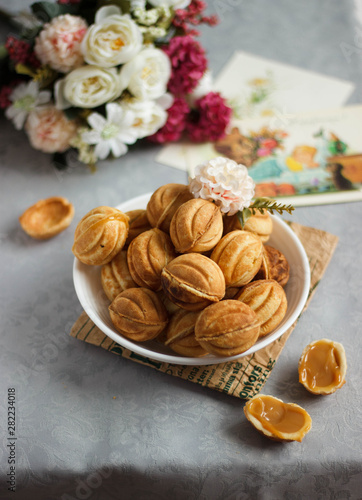 Plate with homemade cookies on grey background, top view. Space for text. Holidays and birthday concept 