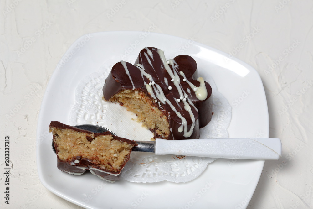 Chocolate dessert in the shape of a flower. Dark chocolate coated. Garnished with white chocolate and sprinkles. Chocolate dessert in the shape of a flower. Dark chocolate coated. Garnished with white chocolate and sprinkles.